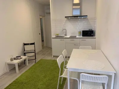 a kitchen with a table and chairs and a kitchen with a sink at City Heart Place 2 in Porto