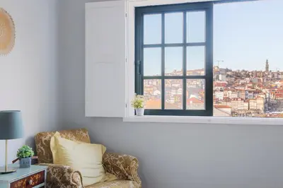 a living room with a chair and a window at MyRiverPlace N 4 Private Terrace River View Porto apartments in Vila Nova de Gaia