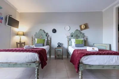a bedroom with two beds and a flat screen tv at MyRiverPlace N 4 Private Terrace River View Porto apartments in Vila Nova de Gaia