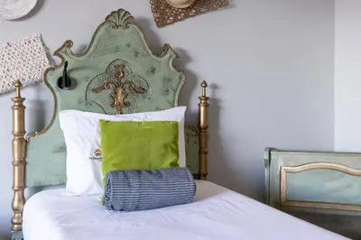 a bed with a green headboard and a green pillow at MyRiverPlace N 4 Private Terrace River View Porto apartments in Vila Nova de Gaia