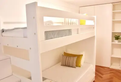a white bunk bed with a bench in a room at OHH - Caldeireiros Luxury Apartments in Porto