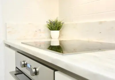 a bathroom sink with a vase with a plant in it at OHH - Caldeireiros Luxury Apartments in Porto