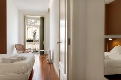 a hotel room with two beds and a window at Hungarian Biscuit Apartment in Porto