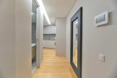 a hallway with a door leading into a kitchen at Premium Style Apt by Porto City Hosts in Porto