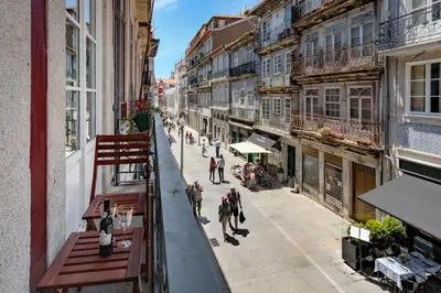 a view of a city street with benches on a balcony at FLORES PLAZA APARTMENT in Porto