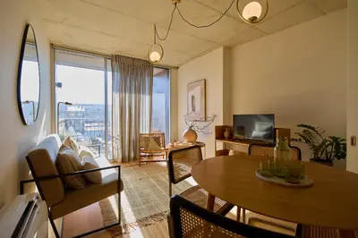 a living room with a dining room table and a television at Oporto Maison Anselmo in Porto