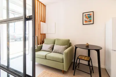 a living room with a couch and a table at Design Boavista Music Apartments in Porto