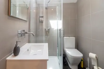 a bathroom with a shower and a sink and a toilet at Design Boavista Music Apartments in Porto