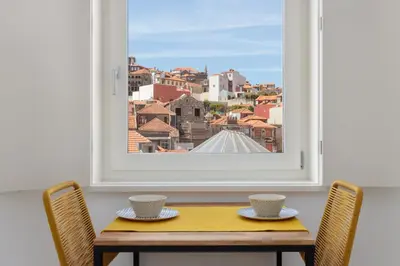 a table with two cups and a window at Oporto Amazing View Apartment in Porto