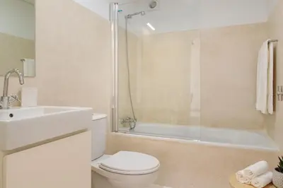 a bathroom with a toilet and a sink and a shower at Oporto Amazing View Apartment in Porto