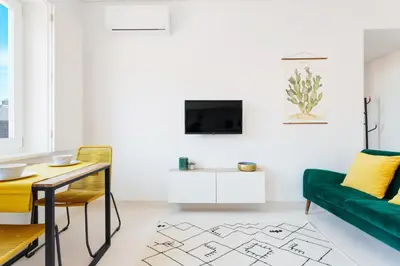 a living room with a green couch and a table at Oporto Amazing View Apartment in Porto