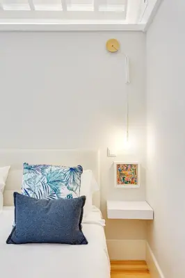 a bedroom with a bed with a blue pillow at DA'HOME - Rola Art Work Studio in Porto