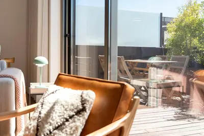 a chair sitting on a balcony with a view of a table at Sunny Loft in Downtown Porto with Private Parking in Porto