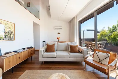 a living room with a couch and a table at Sunny Loft in Downtown Porto with Private Parking in Porto