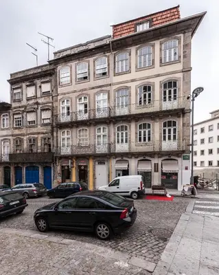 a black car parked in front of a building at Studio with terrace @ historic center in Porto