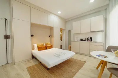 a white room with a bed and a table at A Portuense in Porto
