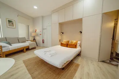 a bedroom with a large bed and a couch at A Portuense in Porto