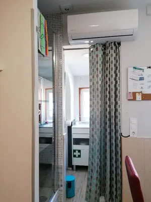 a bathroom with a shower curtain and a sink at House Romantic R/C Right in Porto