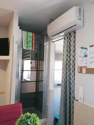 a shower in a small room with a window at House Romantic R/C Right in Porto
