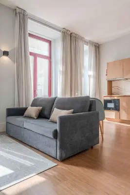a bedroom with a large white bed with two night stands at Uma Formosa Apartments in Porto