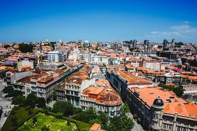 two trolley cars parked next to each other on a street at Uma Formosa Apartments in Porto