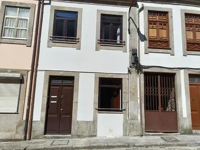 a white building with brown doors and windows at House Romantic II in Porto
