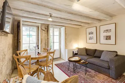 a living room with a couch and a table at Jardins da Muralha Apartments by DA'HOME in Porto