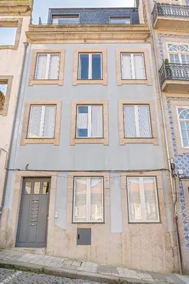 a large brick building with windows and a door at Rooftop Balcony at Porto Historic Center in Porto