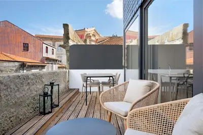 a balcony with two chairs and a table on a building at Rooftop Balcony at Porto Historic Center in Porto
