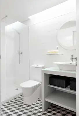 a white bathroom with a toilet and a sink at Rooftop Balcony at Porto Historic Center in Porto