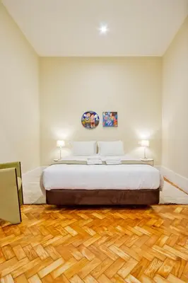 a bedroom with a bed and a wooden floor at Ribeira - Dixos Oporto Apartments III in Porto