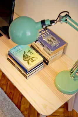 a table with books and a lamp on top at Ribeira - Dixos Oporto Apartments III in Porto