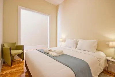 a bedroom with a large white bed with a window at Ribeira - Dixos Oporto Apartments IV in Porto