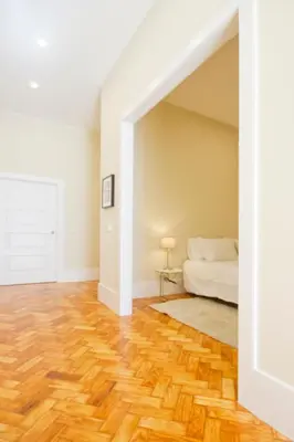 an empty room with a bed and wooden floors at Ribeira - Dixos Oporto Apartments IV in Porto