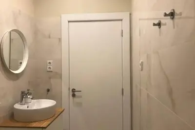 a white bathroom with a sink and a mirror at Ribeira - Dixos Oporto Apartments IV in Porto