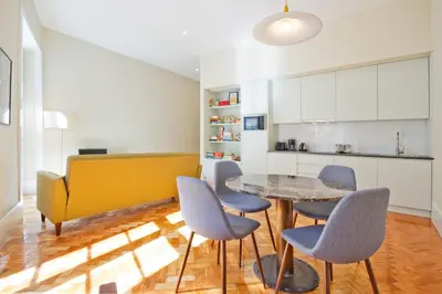 a kitchen and dining room with a table and chairs at Ribeira - Dixos Oporto Apartments IV in Porto