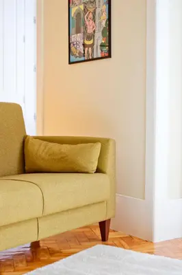 a living room with a couch and a picture on the wall at Ribeira - Dixos Oporto Apartments IV in Porto
