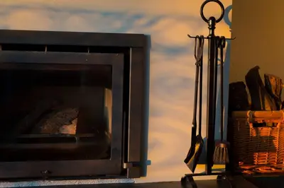 a fireplace with its door open next to a basket at Virtudes Terrace in Porto