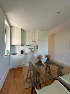 a kitchen with a table and chairs and a table at Guest House Arca de Água in Porto