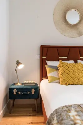 a bedroom with a bed with a blue suitcase on a table at Vintage Luxury House in Porto