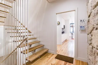 a staircase in a home with white walls and wooden floors at Vintage Luxury House in Porto