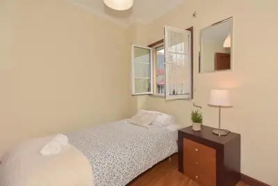 a bedroom with a bed and a table with a lamp at Porto Downtown River in Porto