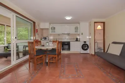 a kitchen and living room with a table and chairs at Porto Downtown River in Porto