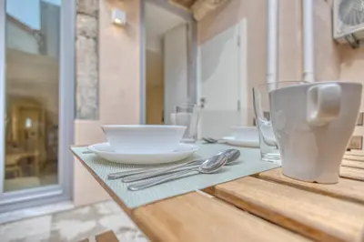 a table with a plate and a bowl and glass at OPORTO GUEST Casa dos Clérigos in Porto