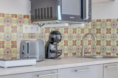 a kitchen counter with a sink and a microwave at OPORTO GUEST Casa dos Clérigos in Porto