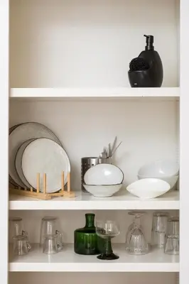 a shelf with plates and bowls and other dishes at Almada Charm Suites & Apartments in Porto