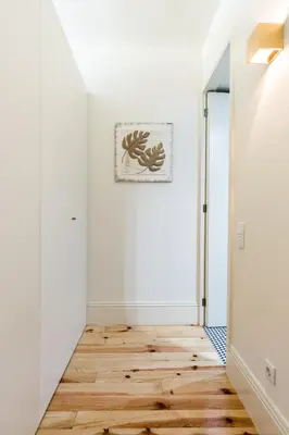 a hallway with white walls and a wooden floor at Wine Luxury House in Porto
