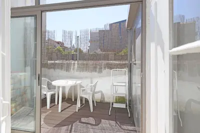a patio with a table and chairs on a balcony at FLH Porto City Apartment with Balcony in Porto