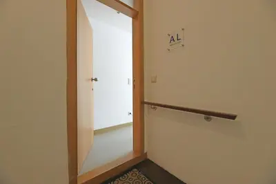 a hallway with a door and a sign on the wall at FLH Porto City Apartment with Balcony in Porto
