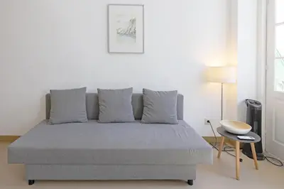 a bedroom with a bed and a table in it at FLH Porto City Apartment with Balcony in Porto